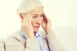 health care, pain, stress, age and people concept - face of senior woman suffering from headache