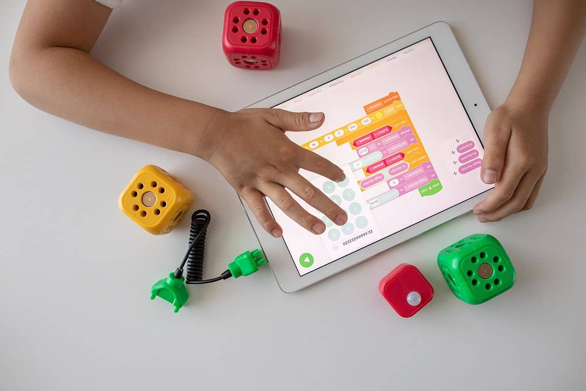 blocks scattered around a tablet; edtech guest post publishers concept