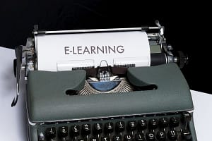 antique typewriter, which has typed the word e-learning; edtech guest post publishers concept