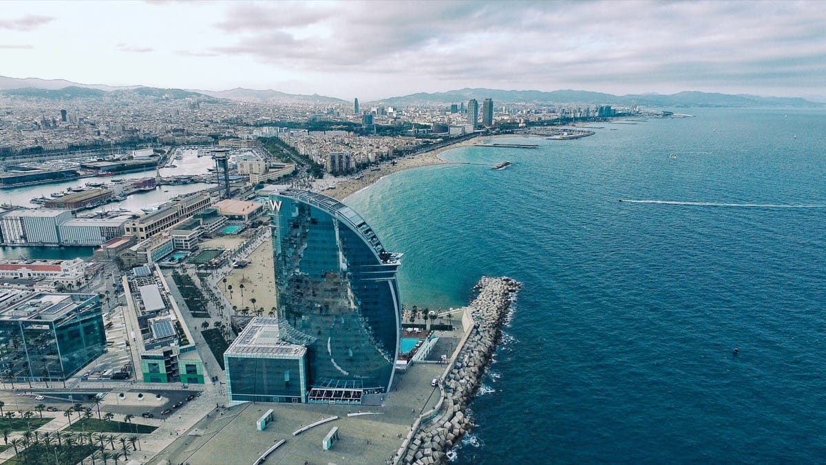 overhead view of the Barcelona beachfront; concept: top SaaS Conferences 2022
