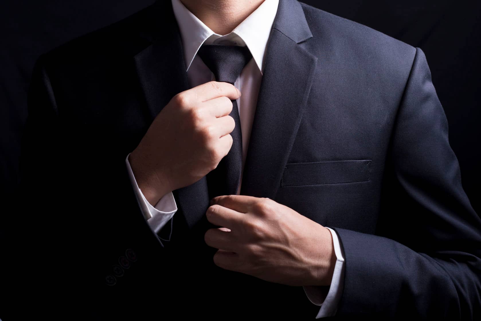businessman adjust necktie his suit